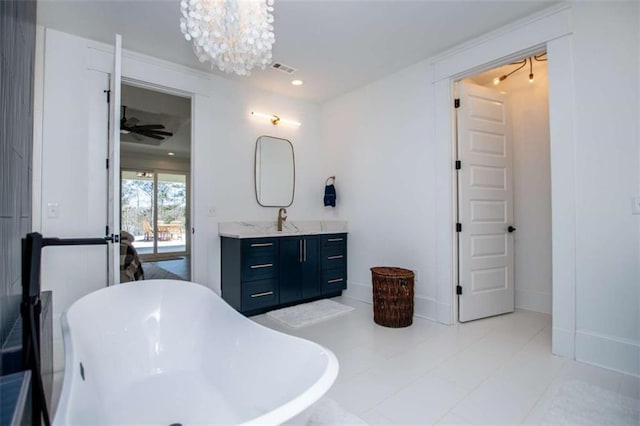 bathroom featuring recessed lighting, ceiling fan with notable chandelier, vanity, baseboards, and a soaking tub