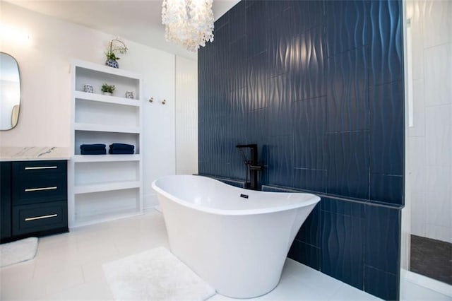 full bath featuring tile patterned flooring, vanity, a freestanding tub, a walk in shower, and tile walls