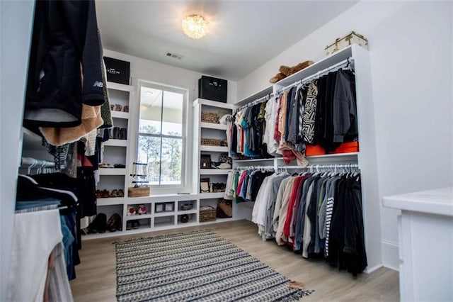 spacious closet with visible vents and wood finished floors