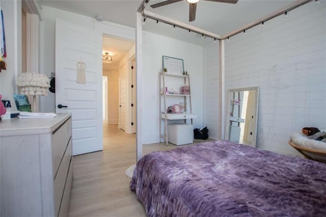 bedroom featuring light wood-type flooring and a ceiling fan