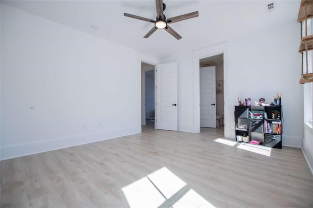 unfurnished bedroom featuring visible vents, ceiling fan, baseboards, and wood finished floors