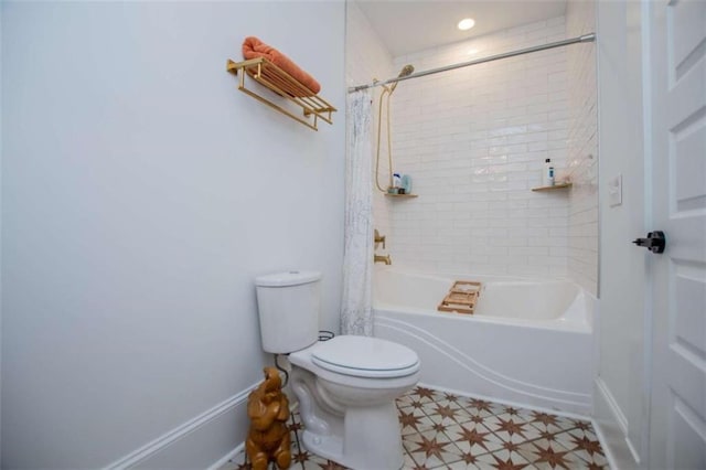 full bathroom with shower / bath combo, baseboards, toilet, and tile patterned floors