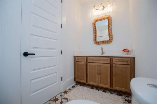 bathroom with toilet and vanity