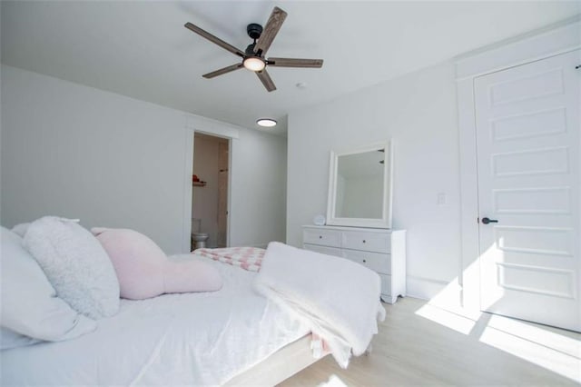 bedroom with connected bathroom and a ceiling fan