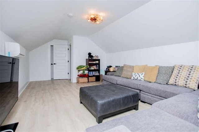 living area featuring light wood-style floors, lofted ceiling, and a wall unit AC