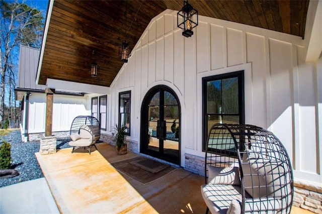 property entrance with stone siding and board and batten siding