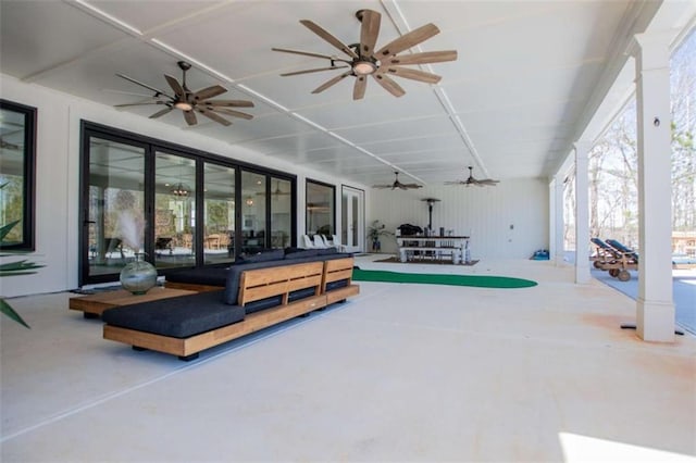 interior space featuring a healthy amount of sunlight, ceiling fan, and decorative columns