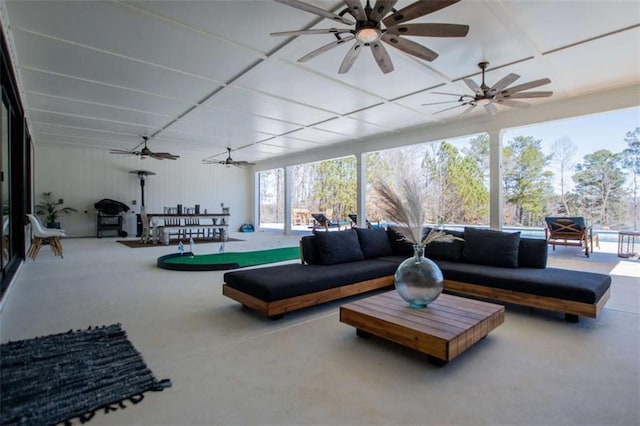 living area with concrete floors and ceiling fan