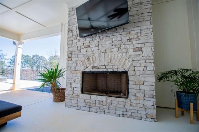 details featuring concrete floors and an outdoor stone fireplace