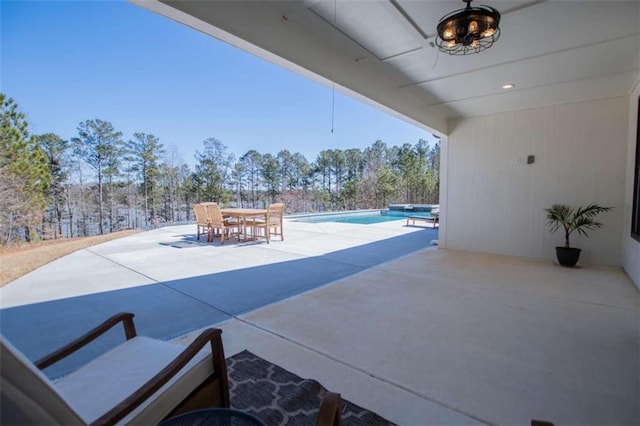 view of patio featuring an outdoor pool and outdoor dining space