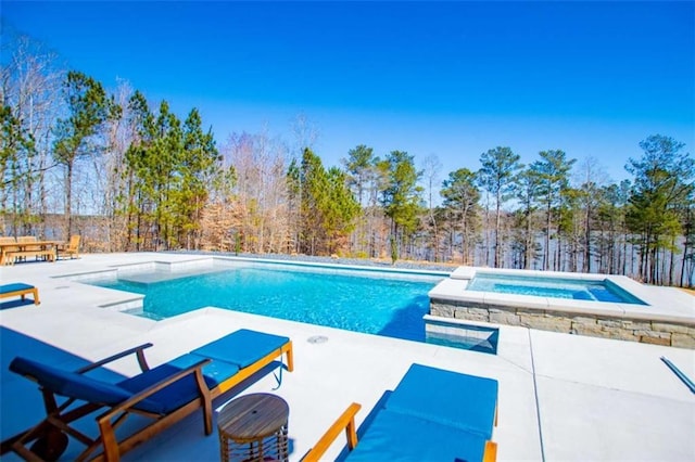 view of swimming pool with an in ground hot tub, a patio, and a fenced in pool