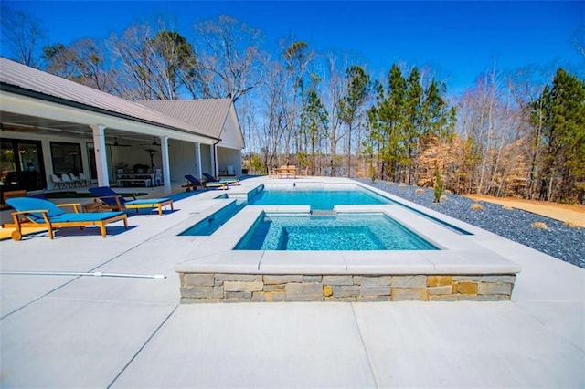 pool with a patio area, ceiling fan, and an in ground hot tub