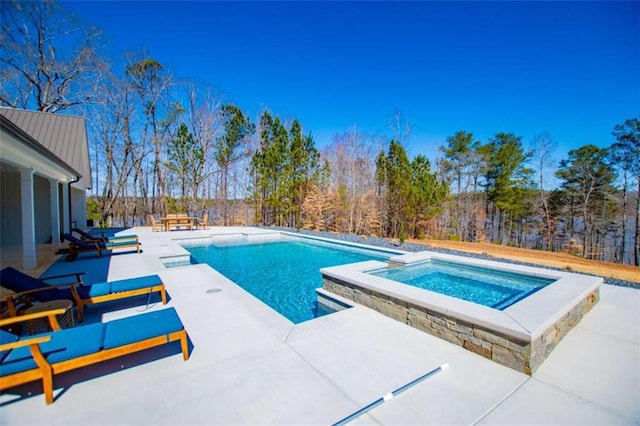 view of swimming pool featuring an in ground hot tub, a fenced in pool, and a patio