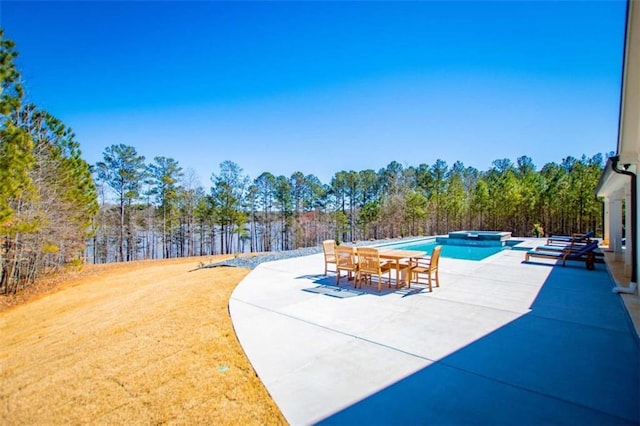 view of pool featuring a patio area and a pool with connected hot tub