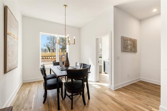 dining room featuring a chandelier and light hardwood / wood-style flooring