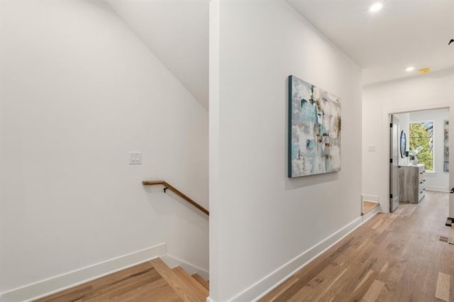 hallway with light hardwood / wood-style flooring