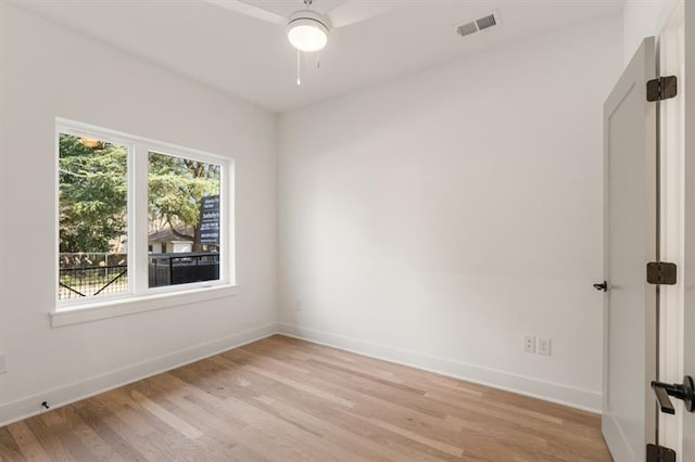 empty room with ceiling fan and light wood-type flooring