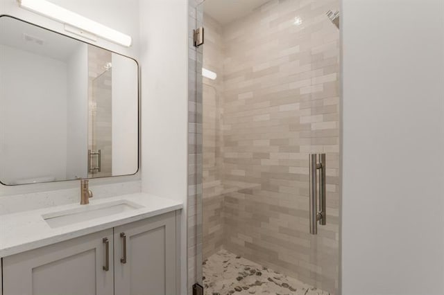 bathroom featuring vanity and a shower with shower door