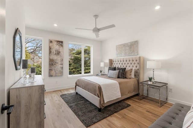 bedroom with ceiling fan and light hardwood / wood-style floors