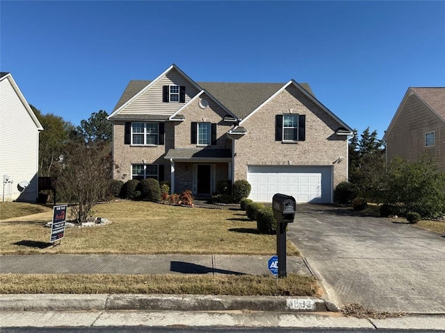 view of front property featuring a front lawn and a garage