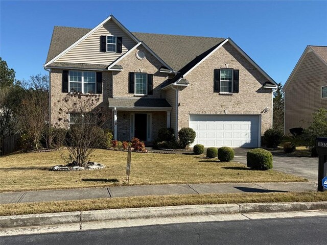 view of property with a front lawn and a garage