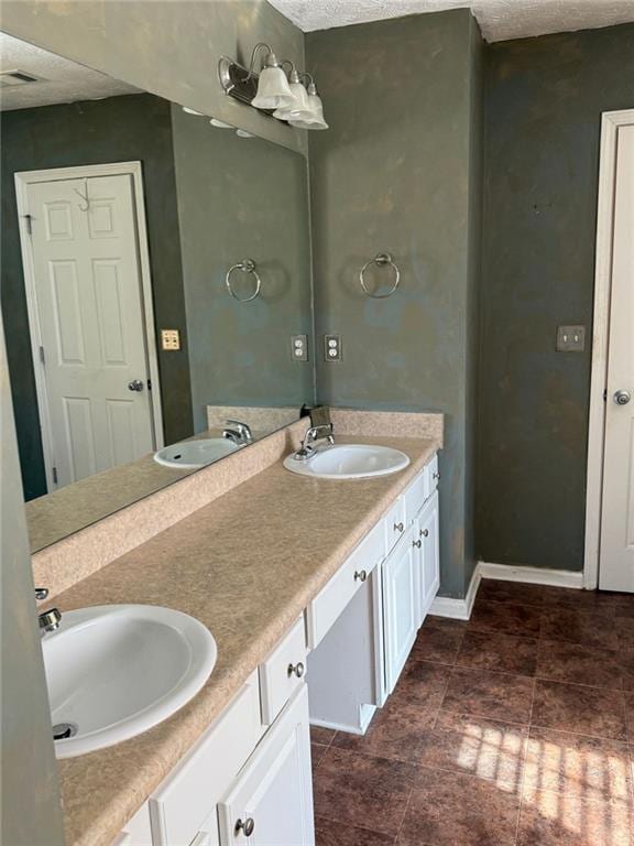 bathroom with vanity and a textured ceiling