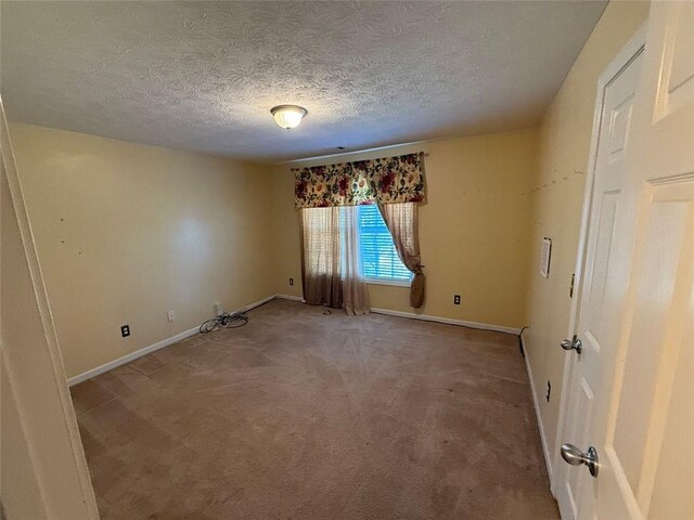 empty room featuring carpet floors and a textured ceiling