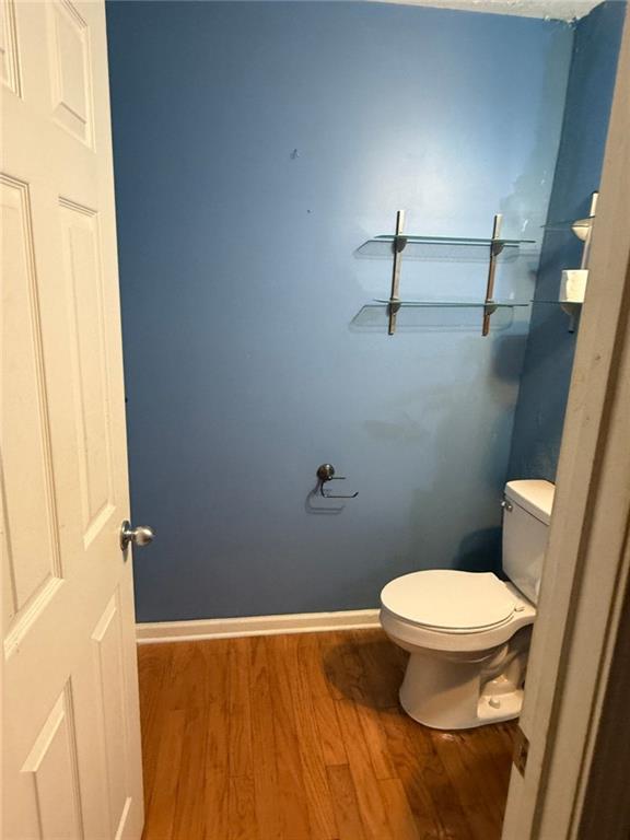 bathroom with hardwood / wood-style floors and toilet