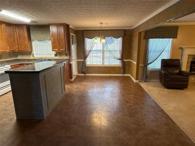 kitchen with stove, a textured ceiling, an inviting chandelier, and hanging light fixtures