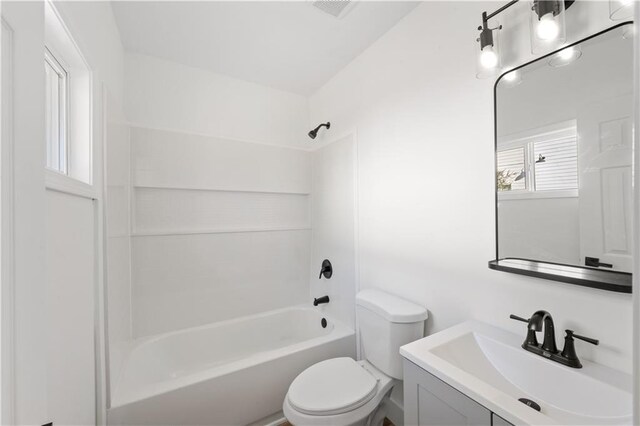 bathroom featuring toilet, visible vents, tub / shower combination, and vanity