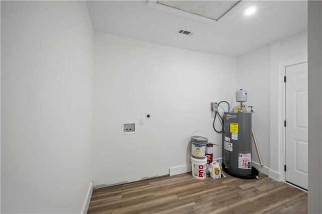 utility room featuring water heater and visible vents