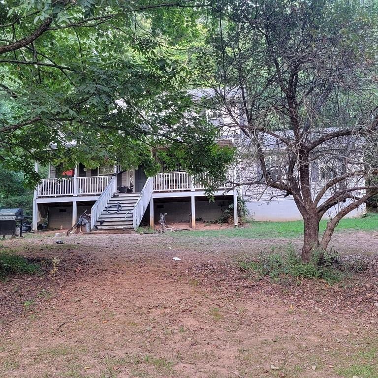 view of front of property with stairway and a wooden deck