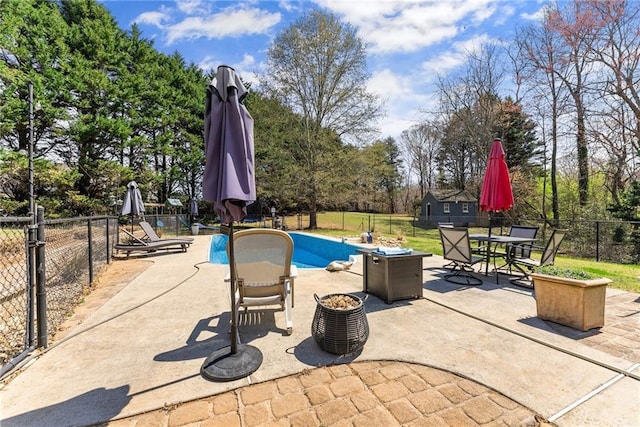 view of pool with a patio, a fenced backyard, outdoor dining space, a fenced in pool, and a lawn