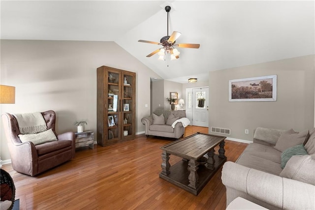 living area with a ceiling fan, lofted ceiling, baseboards, visible vents, and light wood-style floors