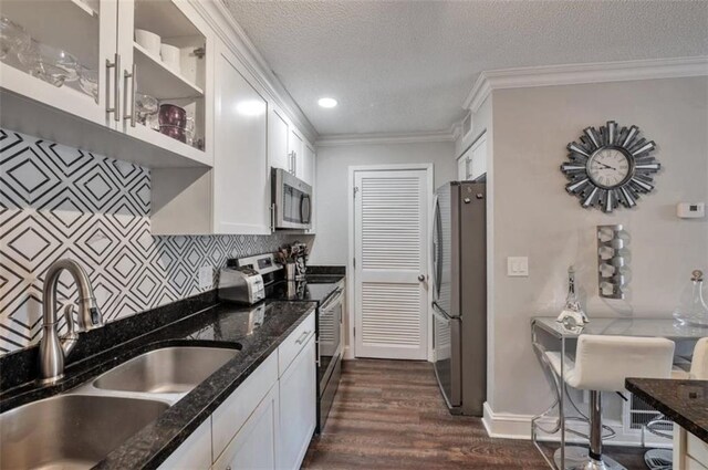 2657 Lenox Rd Unit C30, Atlanta, GA 30324 - kitchen with white cabinets, glass insert cabinets, stainless steel appliances, and a sink