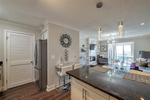 2657 Lenox Rd Unit C30, Atlanta, GA 30324 - kitchen with freestanding refrigerator, open floor plan, decorative light fixtures, and white cabinets