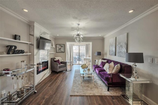 2657 Lenox Rd Unit C30, Atlanta, GA 30324 - living room featuring ornamental molding, dark wood-style flooring, a fireplace, and an inviting chandelier
