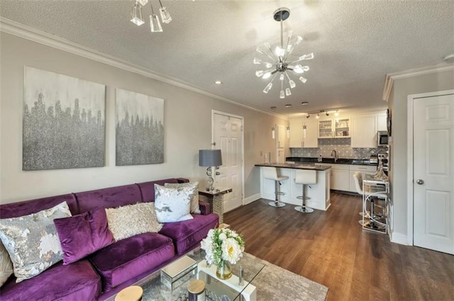 2657 Lenox Rd Unit C30, Atlanta, GA 30324 - living room with crown molding, dark wood finished floors, a textured ceiling, a chandelier, and baseboards