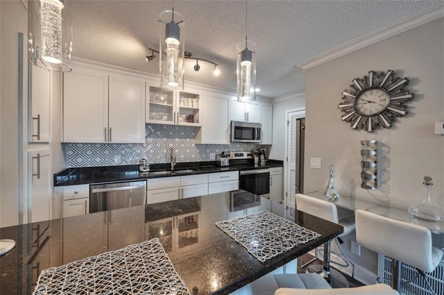 2657 Lenox Rd Unit C30, Atlanta, GA 30324 - kitchen featuring a sink, white cabinetry, a kitchen breakfast bar, appliances with stainless steel finishes, and glass insert cabinets