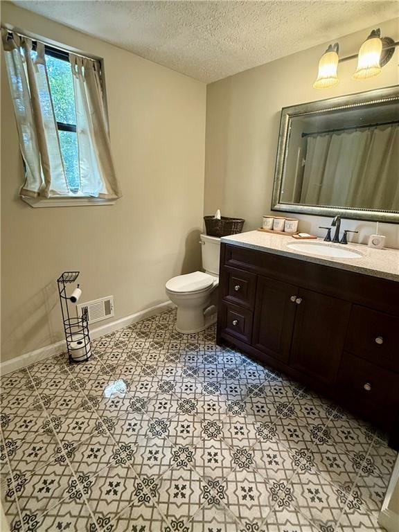 8327 Commanche Ct, Jonesboro, GA 30236 - bathroom with vanity, a textured ceiling, and tile patterned flooring