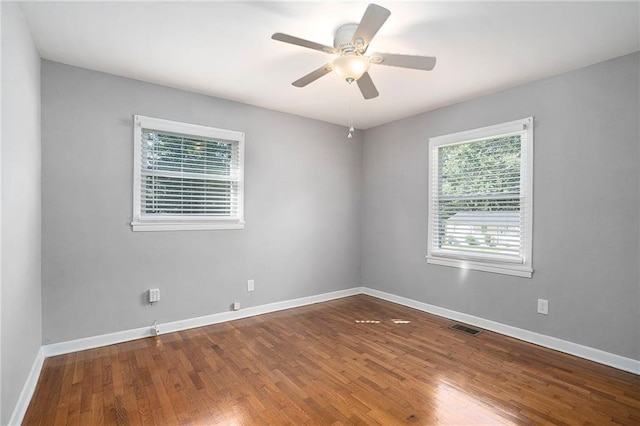 empty room featuring ceiling fan and hardwood / wood-style floors