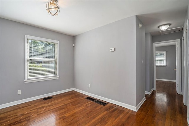 spare room with dark hardwood / wood-style floors