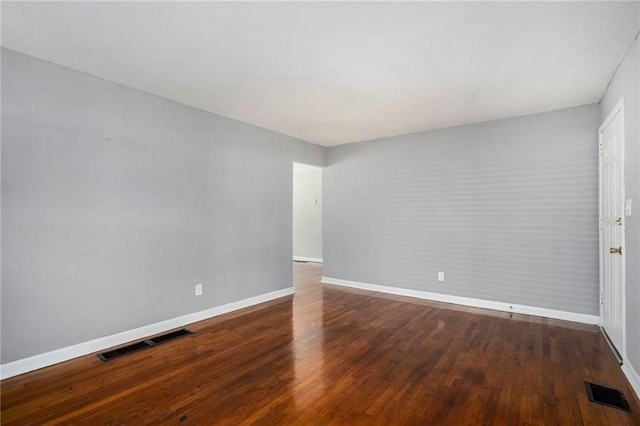 unfurnished room with dark hardwood / wood-style floors