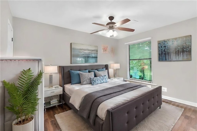 bedroom with ceiling fan and dark wood-type flooring