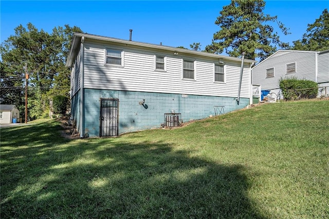 rear view of property with a lawn