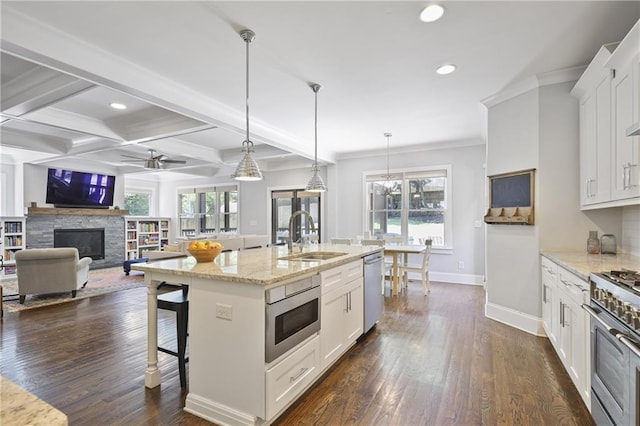 1297 Conway Rd, Decatur, GA 30030 - kitchen with a sink, appliances with stainless steel finishes, recessed lighting, baseboards, and a stone fireplace
