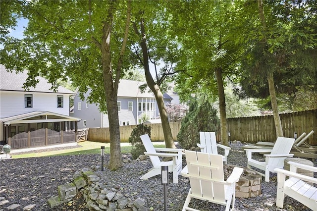 1297 Conway Rd, Decatur, GA 30030 - fenced backyard featuring an outdoor fire pit, a sunroom, and a patio area