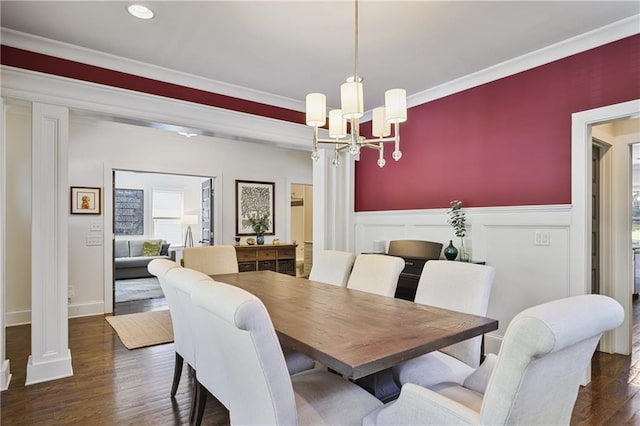 1297 Conway Rd, Decatur, GA 30030 - dining room with a chandelier, a wainscoted wall, dark wood-style floors, ornamental molding, and decorative columns