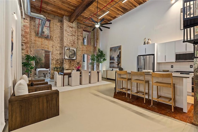 170 Boulevard Se 115E, Atlanta, GA 30312 - interior space with a high ceiling, wooden ceiling, ceiling fan, brick wall, and finished concrete flooring