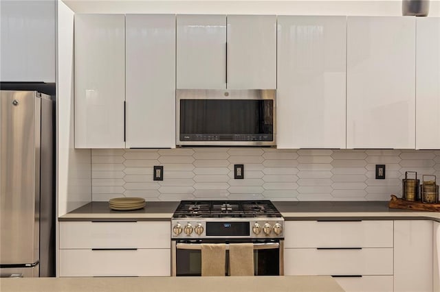 170 Boulevard Se 115E, Atlanta, GA 30312 - kitchen featuring stainless steel appliances, white cabinetry, backsplash, and modern cabinets